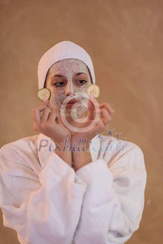 Spa Woman applying Facial Mask  Beauty Treatments  Close up portrait of beautiful girl with a towel on her head applying facial mask