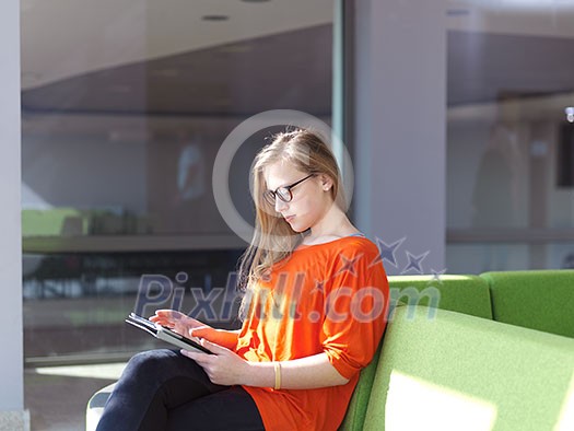happy student girl working on tablet computer at modern school university indoors happy student girl working on tablet computer at modern school university indoors