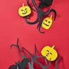 Halloween composition of handcraft paper pumpkins, bats and trees on a red background with copy space. Flat lay