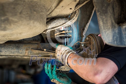 Inside a garage - changing wheels/tires (shallow DOF; color toned image)