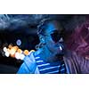 young african american man smiking cigarette with neon ligts and disco party at night