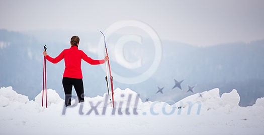 Cross-country skiing: young woman cross-country skiing on a  winter day (motion blurred image)