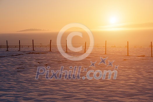 Beautiful winter landscape during sunset over snow covered field Beautiful winter landscape during sunset over snow covered field