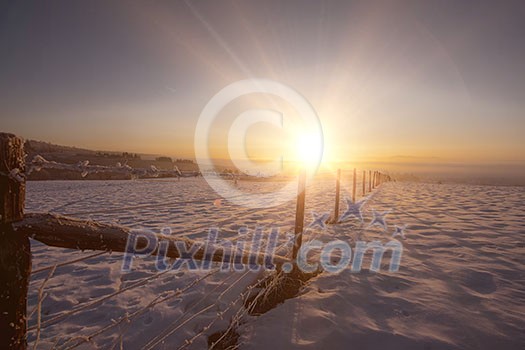 Beautiful winter landscape during sunset over snow covered field Beautiful winter landscape during sunset over snow covered field