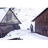 portrait of confident traditional senior blacksmith worker standing in front of old watermill at winter time