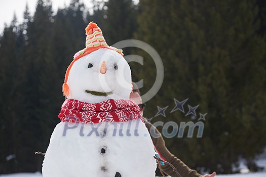 happy young  couple having fun and walking in snow shoes outdoor in nature at beautiful winter day. Health sport and relaxation