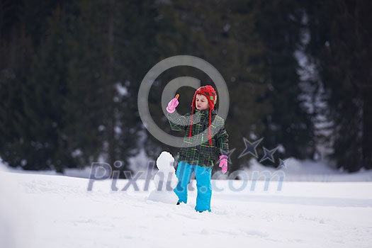 little boy making snowman