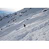 extreme freeride skier skiing on fresh powder snow in downhill at winter mountains