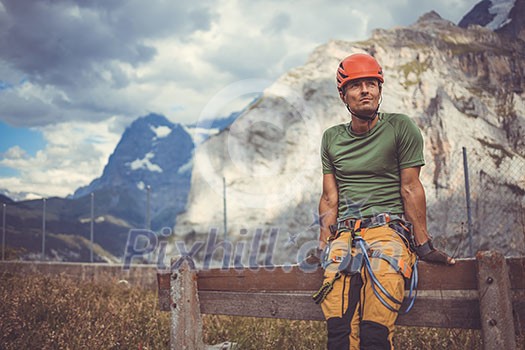 Young man climbing on a rock in Swiss Alps - via ferrata/klettersteig