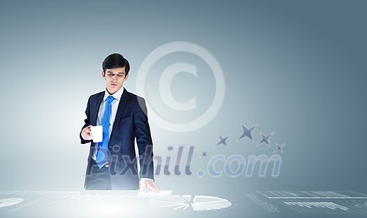 Young businessman and statistics information at background