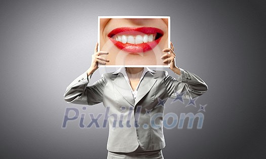 Unrecognizable businesswoman holding big photo with lips Unrecognizable businesswoman holding big photo with lips