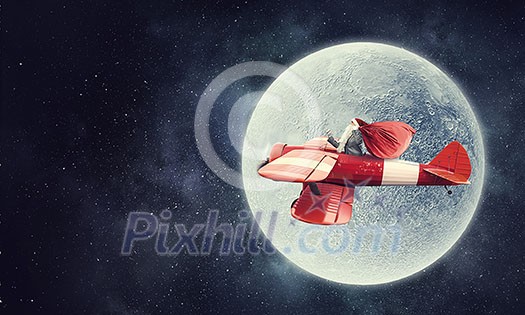 Santa Claus flying in airplane high in sky