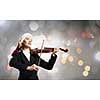 Woman in formal suit and Santa hat playing violin