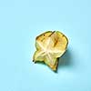 Fresh ripe exotic fruit carambola, star apple on a pastel blue background with plac under text.