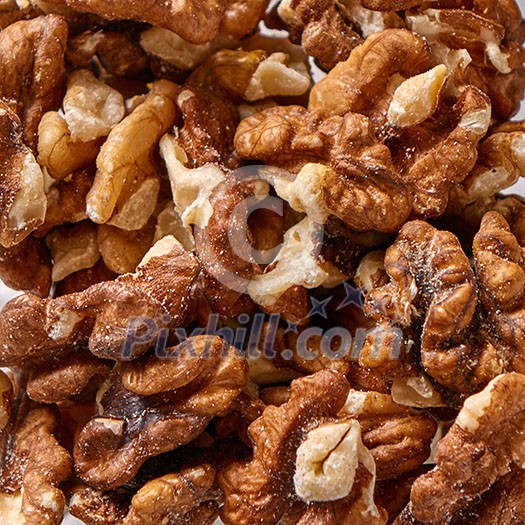 Texture of natural walnuts background. Natural organic food for diet vegetarian eating. Top view. Texture of natural walnuts background. Natural organic food for diet vegetarian eating. Top view.