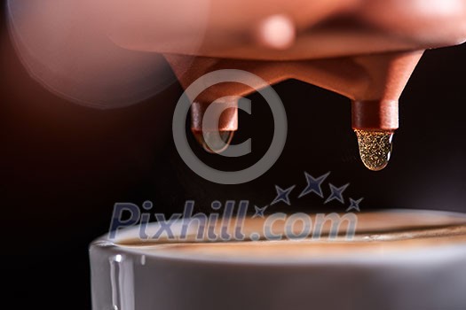 Macro photo of a coffee machine with drops of drink and a cup of freshly made coffee. Espresso Brewing