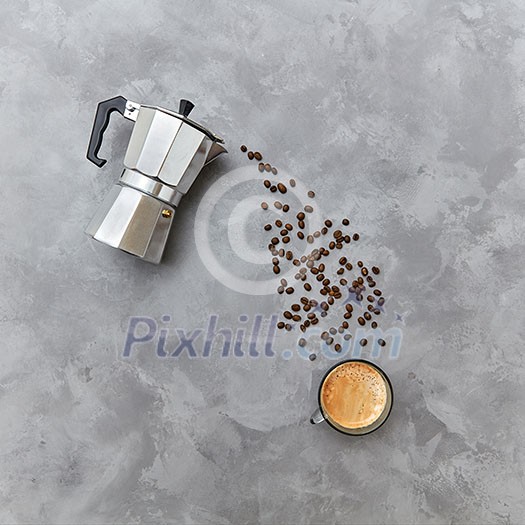 The cup of morning coffee and coffee maker with beverage from coffee beans in the form of a drink stream, place for text. Morning coffee concept. Top view. The cup of morning coffee and coffee maker with beverage from coffee beans in the form of a drink stream, place for text. Morning coffee concept. Top view.