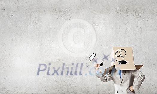 Businessman wearing carton box with drawn emotions on head Businessman wearing carton box with drawn emotions on head