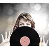 Young woman in casual holding disco plate