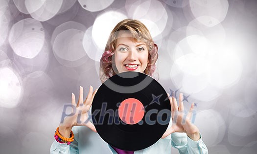 Young woman in casual holding disco plate on bokeh background