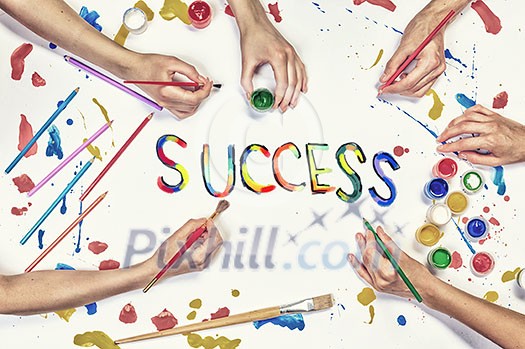 Top view of people hand drawing business creative concept with paints Top view of people hand drawing business creative concept with paints