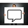 Young businessman showing blank white speech banner. Place for text