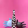 Creative composition with painted wine bottle of black spots and two rubber surgical balloon gloves on a hot pink background, copy space.