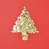 Creative Christmas decoration Tree from small shiny spruces on a red background with copy space. Greeting holiday card.