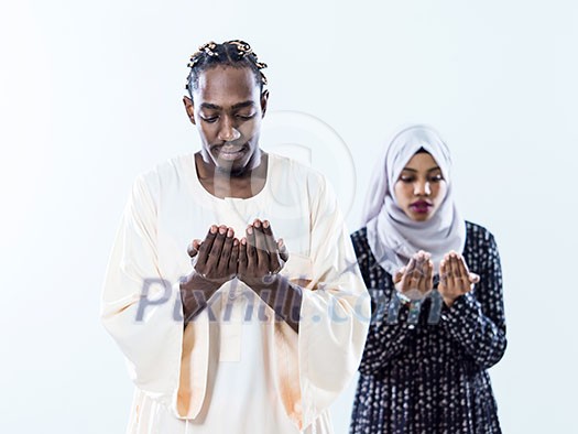 african muslim couple praying Allah by raising hands and making fatiha pray isolated on white background african muslim couple praying Allah by raising hands and making fatiha pray isolated on white background