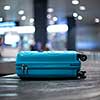 Arrived luggage going around on a conveyor belt waiting to be claimed at the baggage claim zone at a modern international airport