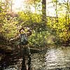 Fly fisherman working the line and the fishing rod while fly fishing on a splendid mountain river for rainbow trout