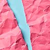 Crumpled hot pink paper on a pastel blue as a handcraft decorative background for your creativity with place for text.