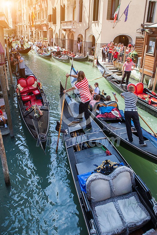 Several gondolas with gondoliers in Venice, Italy. Beautiful view on Grand Canal. Several gondolas with gondoliers in Venice, Italy. Beautiful view on Grand Canal.