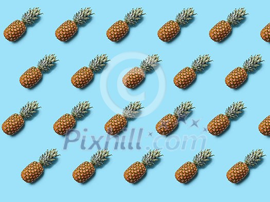 Exotic fruit pineapple with leaves on a blue background as layout for your ideas. Flat lay
