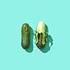 Peeled and whole cucumbers on a blue background with reflection of shadows and copy space for text. Healthy Diet Food. Top view