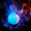 Abstract explosion of smoke colorful ball in blue, red and violet colours on a dark background with copy space.
