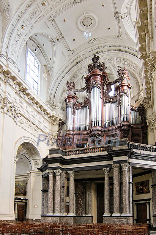 Interior of huge historical catholic cathedral with big organ and places of worship, traditional medieval temple in Europe. Interior of huge historical catholic cathedral with big organ and places of worship, traditional medieval temple in Europe.