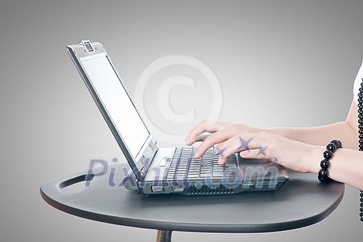 Close up of woman's hands using laptop and splashes out of monitor