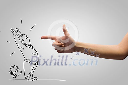 Close up of human hand attacking businessman caricature Close up of human hand attacking businessman caricature