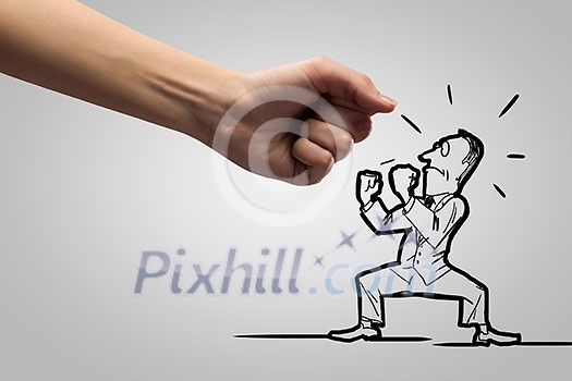 Close up of human fist fighting with businessman caricature Close up of human fist fighting with businessman caricature