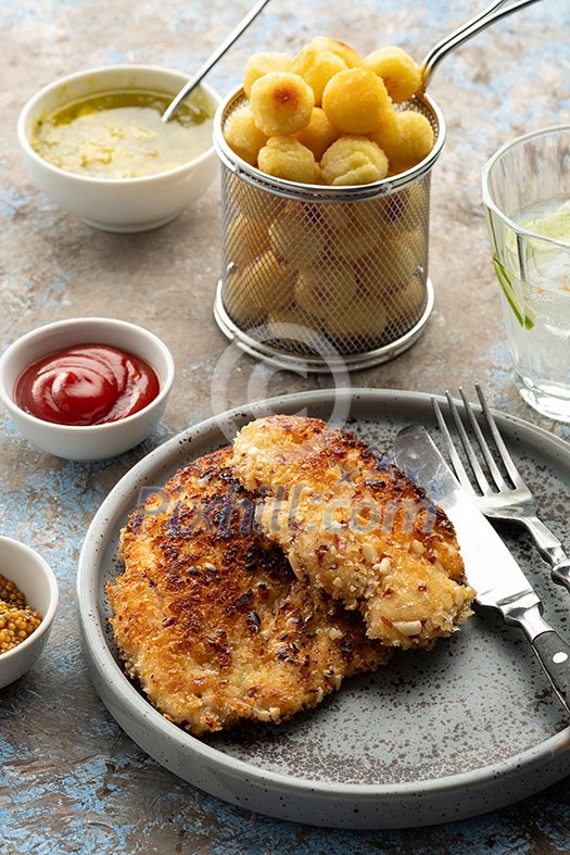 Wiener schnitzel with potato balls and lemon sauce. Breaded Chicken Schnitzel with Garnish. Wiener schnitzel with potato balls and lemon sauce. Breaded Chicken Schnitzel with Garnish.