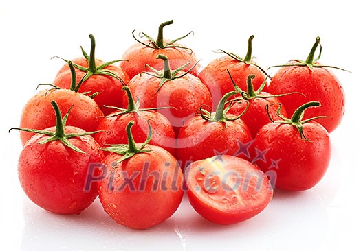 Ripe tasty red tomatoes with dew drops on a white background