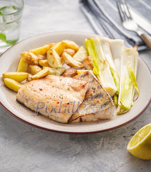 Fried pike perch with potatoes and vegetables