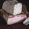 Pork fatback on wooden table. Rustic style. Toned image.