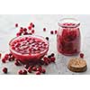 Cranberry jam in a glass bowl on a gray background