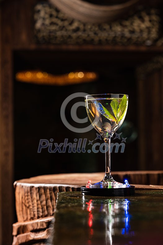 Transparent Alcoholic cocktail with mint on the bar counter Transparent Alcoholic cocktail with mint on the bar counter