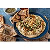 Classic Hummus with chickpeas, paprika, olive oil and oriental spices. Mediterranean popular snack of chickpeas and tahini pasta.