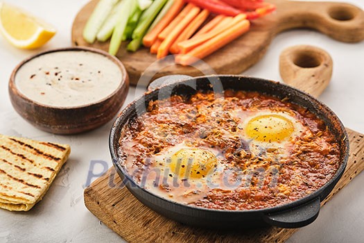 Shakshuka, Fried Eggs in Tomato Sauce. Traditional Mediterranean Fried Eggs. Israeli cuisine Shakshuka, Fried Eggs in Tomato Sauce. Traditional Mediterranean Fried Eggs. Israeli cuisine