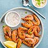 Shrimp glazed in soy sauce with green onion and lemon. Top view.