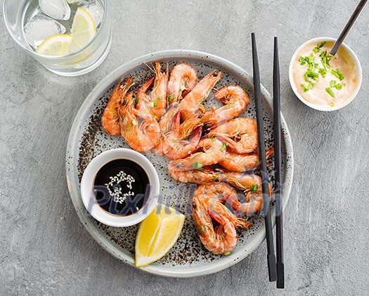 Shrimp glazed in soy sauce with green onion and lemon Shrimp glazed in soy sauce with green onion and lemon